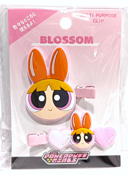 The Powerpuff Girls Blossom themed hair clip featuring a high-quality die-cut character embellishment of Blossom with her iconic large red bow, orange hair, and pink outfit on a pvc material hair accessory.